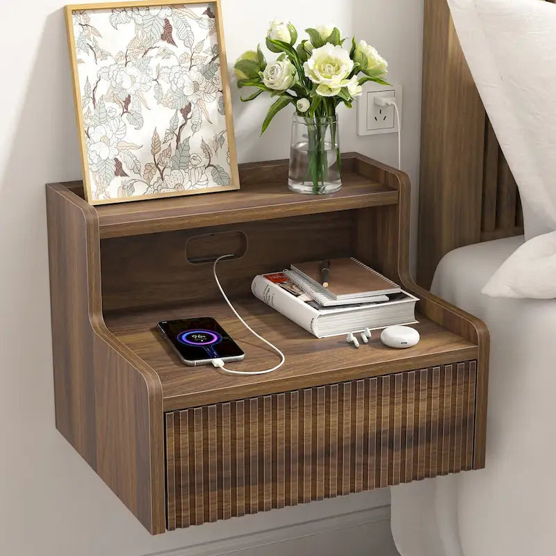 Modern floating bedside table with storage drawers and open shelves.