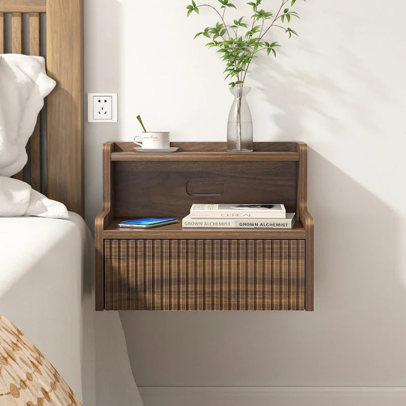 Modern floating bedside table with storage drawers and open shelves.